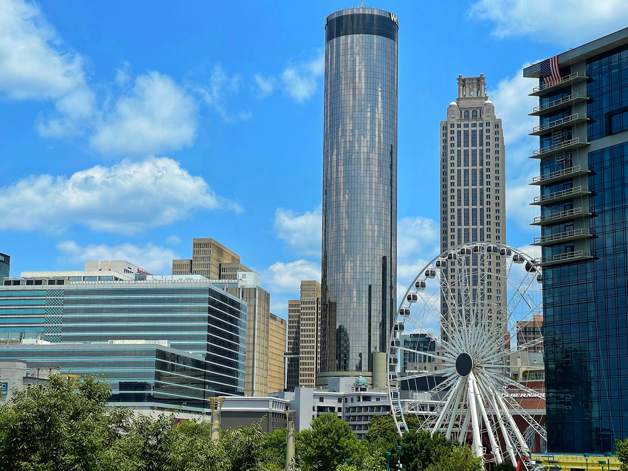 Downtown Atlanta buildings and Ferris wheel beneath a blue sky