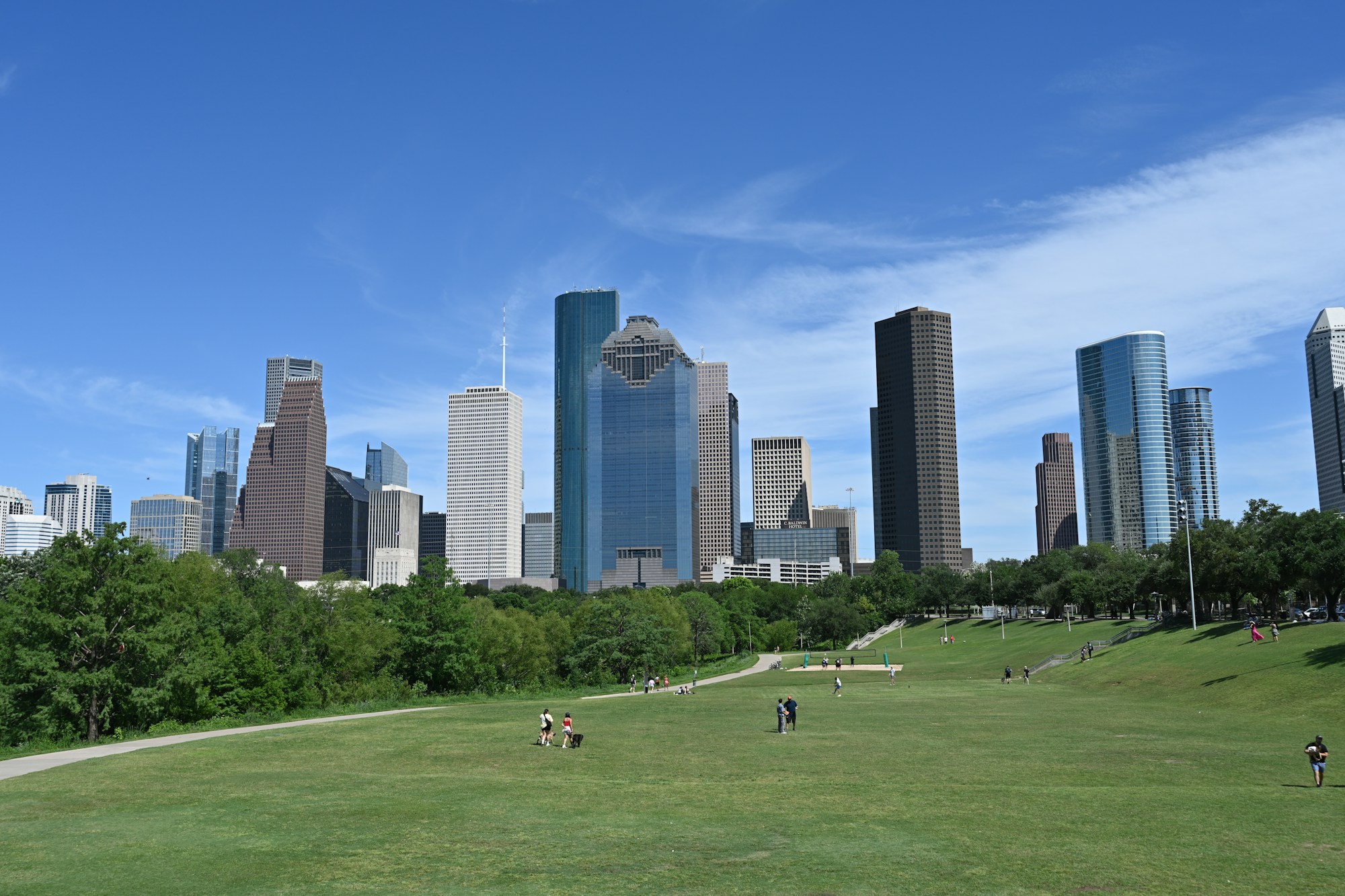 Houston skyline above a green park in daylight